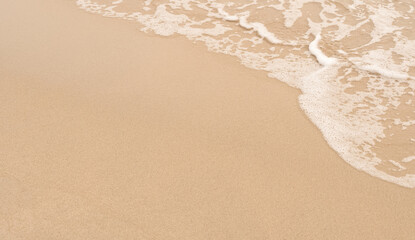 Sand texture background,Top view sandy beach, soft ocean wave with for Summer background,Aerial beach seaside, brown sand with sea foam,Backdrop aerial beach clam and relaxing of Nature Background
