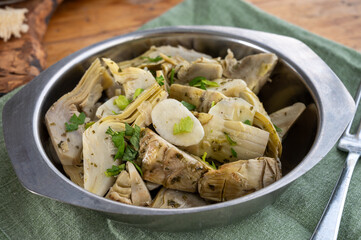 Italian food, pickled grilled artichokes hearts in olive oil close up