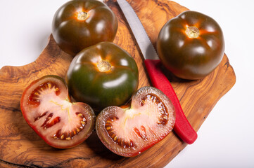 Fresh ripe sweet reddish brown and green kumato tomatoes close up