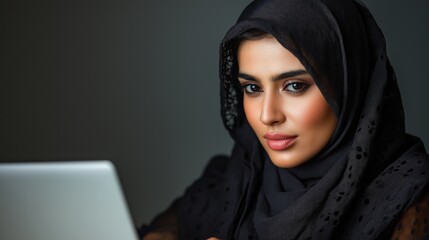In a moment of introspection, a Muslim woman adorned in a stylish hijab engages deeply with her thoughts. The soft lighting highlights her serene expression, embodying the spirit of Ramadan