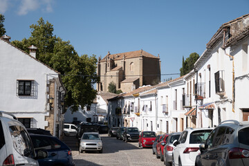 Fototapeta premium Narrow hilly streets and white houses of Ronda, touristic town in Andalusia, Pueblo Blanco white village, Spain.