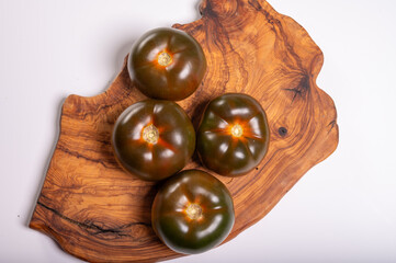 Fresh ripe sweet reddish brown and green kumato tomatoes close up