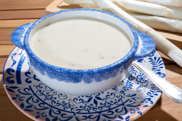 Spring season, homemade soup from raw white asparagus and cooked eggs, new harvest of Dutch, German white asparagus