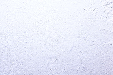 Close up view of a white wall with a grainy texture