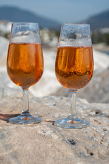 Drinking rose champagne or cava sparkling wine in  Puerto Banus in Marbella, Spain. Sandy beaches, luxury yacht harbour in Costa del Sol, Andalusia.