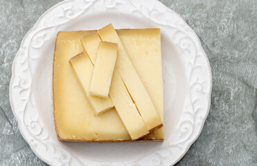 French cheese Comte, varieties unpasteurised ed milk Prestige, fruity flavoured Fruite and Vieille Reserve close up