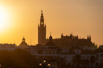 Naklejka premium Sunrise in old historical Andalusian town Seville, Spain. View on houses, canal with boats, architectural details of buidings. Summer in Andalusia.