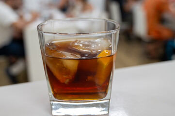 Tasting Sherry sweat cream wine on ice rocks, jerez fortified wine made from palomino white grape served in Jerez de la Frontera, Cadiz, Andalusia, Spain