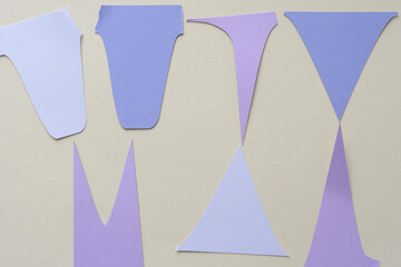 set of mostly machine-cut paper shapes on blank beige paper