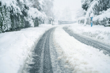 Fototapeta premium Snow covered winter road during snowstorm