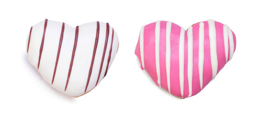 Two heart shaped Valentines Day  donuts isolated on a white background. Pink and white with icing stripes. Top down view.
