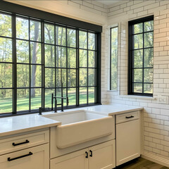 architectural style kitchen with large black windows and farmhouse sink