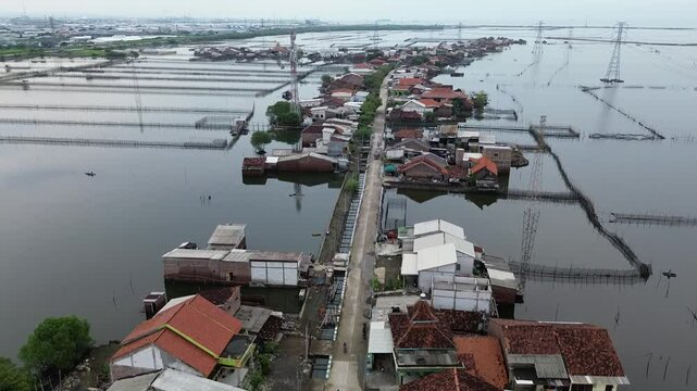 An area in Demak, Central Java, Indonesia, experiences daily tidal flooding, leading to land erosion and the destruction of houses. This is a direct impact of climate change and global warming.