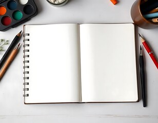 Blank sketchbook surrounded by art supplies ready for creative work