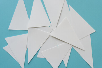 pile of machine-cut isosceles triangles on blue paper