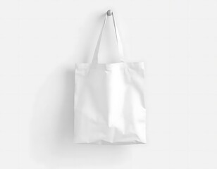 A White Tote Bag Hangs Against A White Wall