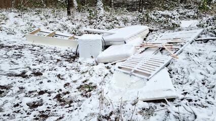 snow covered illegal dump in the forest