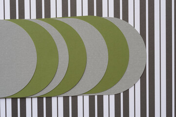 round shapes arranged in staggered form on black and white paper with stripes