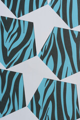 white paper arrows (paper stencil with polygonal frames) on blue and black card-stock