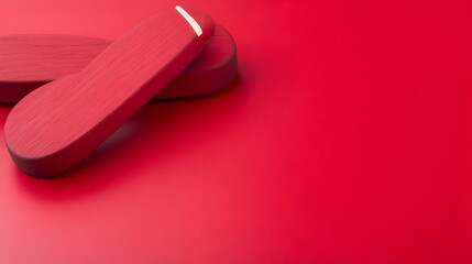 Red oblong objects on red background; minimalist product shot; copy space; technology concept; website banner.