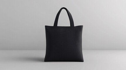 Simple black tote bag placed on a clean surface with a neutral background