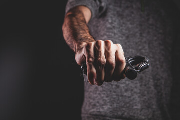 Fototapeta premium a hand holding a black metal chain.