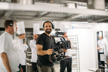 Director of photography with a camera in his hands on the set. Professional videographer at work on...
