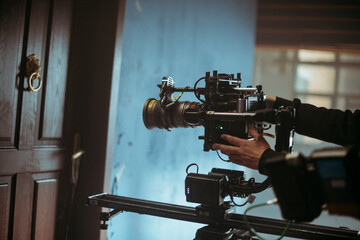 Professional cinema and video camera on the set. Shooting shift, lighting fixtures, shooting equipment and the team. Technique of modern filming and advertising.