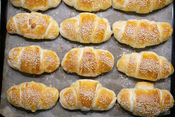 Top view of homemade mini croissants on a sheet pan