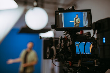 Professional cinema and video camera on the set. Shooting shift, lighting fixtures, shooting equipment and the team. Technique of modern filming and advertising.