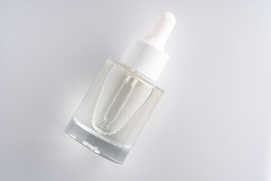 Mockup of Cosmetic glass bottle with dropper for essential oils and serum on white. The concept of a beauty salon and natural cosmetics.