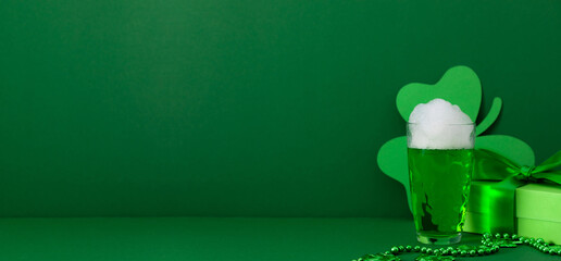 St. Patrick's Day concept with green beer, gift and clover. Saint Patrick's Day celebration,...