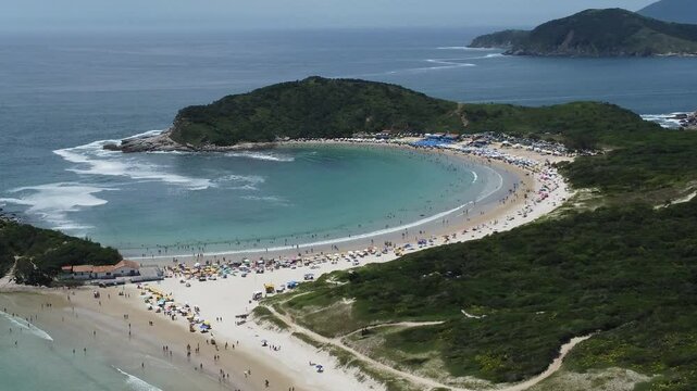 Aerial drone footage of Praia das Conchas (Shells Beach) in Cabo Frio, Rio de Janeiro, Brazil. Discover its calm turquoise waters, crescent-shaped shoreline, and breathtaking natural beauty.