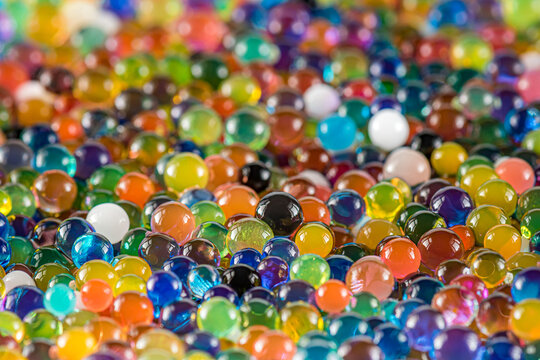 Water beads close-up, abstract background. Texture of Hydrogel balls or many colorful orbeez for wallpaper.