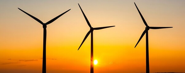 Fototapeta premium Wind turbines amidst golden hour light, soft and serene