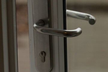 This is a closeup view that highlights the intricate design and functionality of a door handle and lock mechanism, illustrating detail