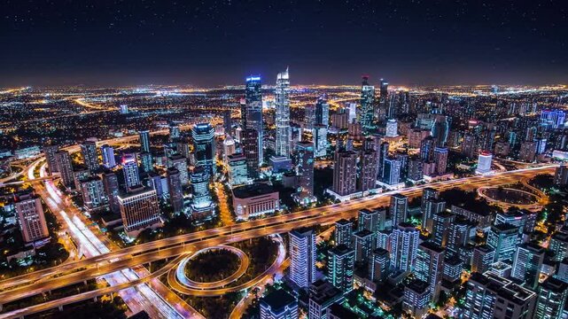 Night view of a bustling city skyline showcasing lights and architecture from a high vantage point