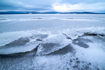 Wide-angle landscape view of the frozen rural lake Lipno.
