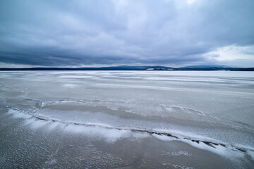 Wide-angle landscape view of the frozen rural lake Lipno.