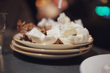 Crumpled used napkins and leftover food standing on a table in a restaurant