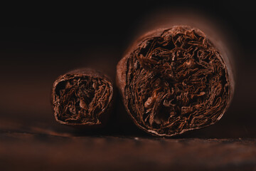 Cuban cigars on dark wooden background. Selective focus. Toned.