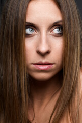 Fototapeta premium Close-Up Portrait of a Woman With Thoughtful Expression and Long Hair