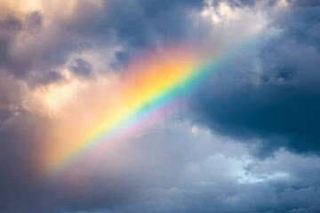 Fototapeta premium rainbow arching across a stormy sky, with sunlight breaking through dark clouds, minimal background with copy space