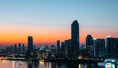 Naklejka premium City skyline at dusk with vibrant colors.