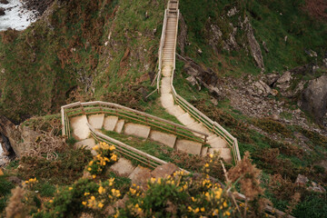 A zigzagging path carved into the dramatic cliffs of Galicia, offering breathtaking views.