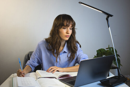 Tired worker working late in front of the laptop 