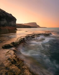 Breathtaking Sunset at Cape Greco Cyprus with Flowing Tides and Rugged Coastal Rocks Creating a Stunning Mediterranean Landscape