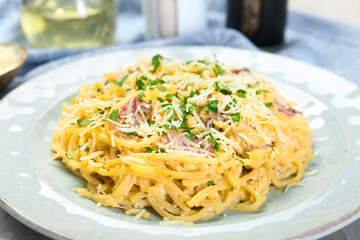 Delicious pasta Carbonara with bacon on table, closeup