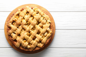 Tasty homemade apple pie on white wooden table, top view. Space for text