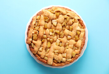 Tasty homemade apple pie on light blue background, top view